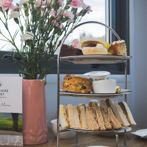 Afternoon Tea with a tray of scones and sandwiches