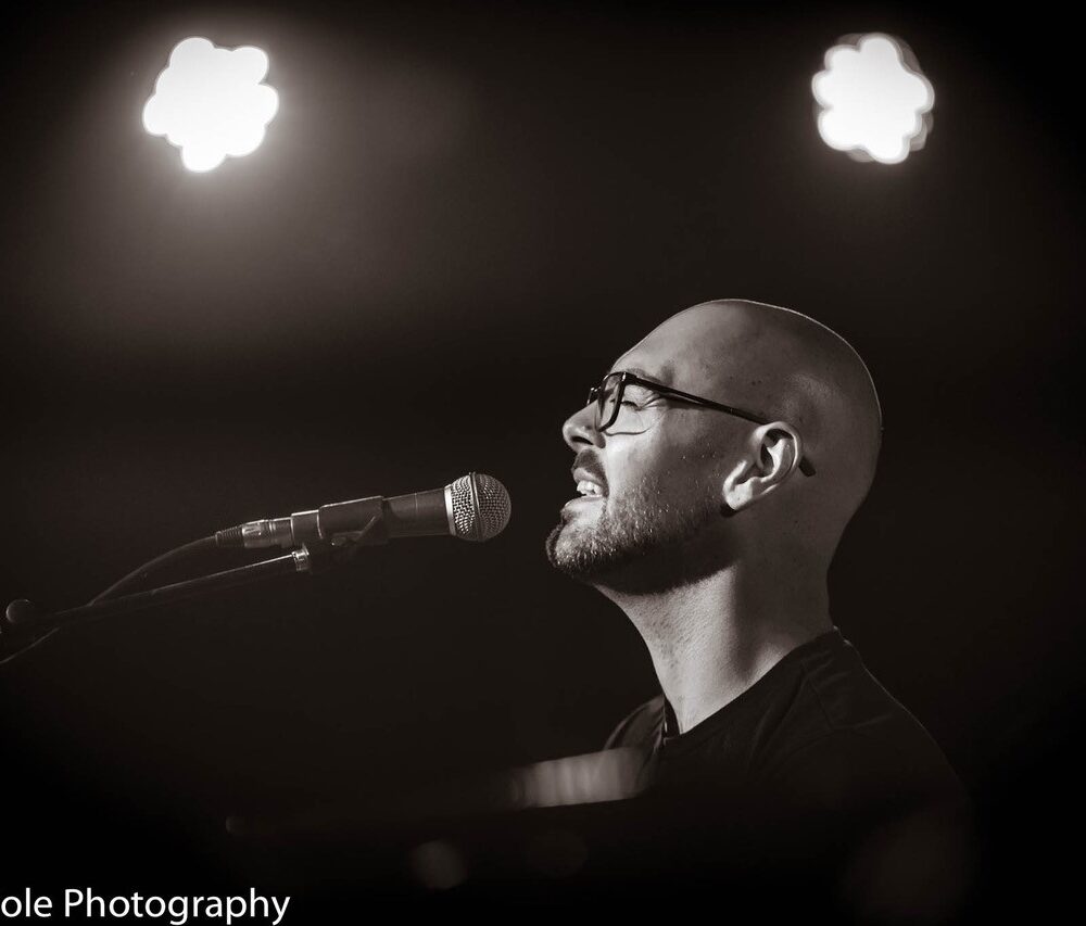 Dan Burnett singing black and white