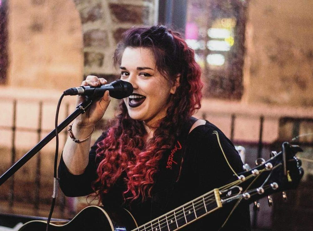 Kelly Ann Bolland singing facing camera