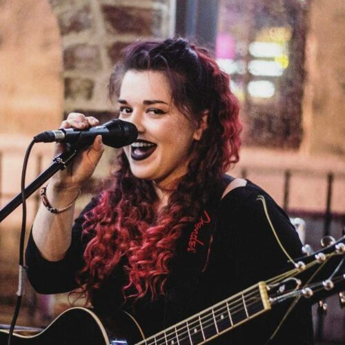 Kelly Ann Bolland singing facing camera