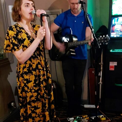 Billy and Lu playing guitar and singing