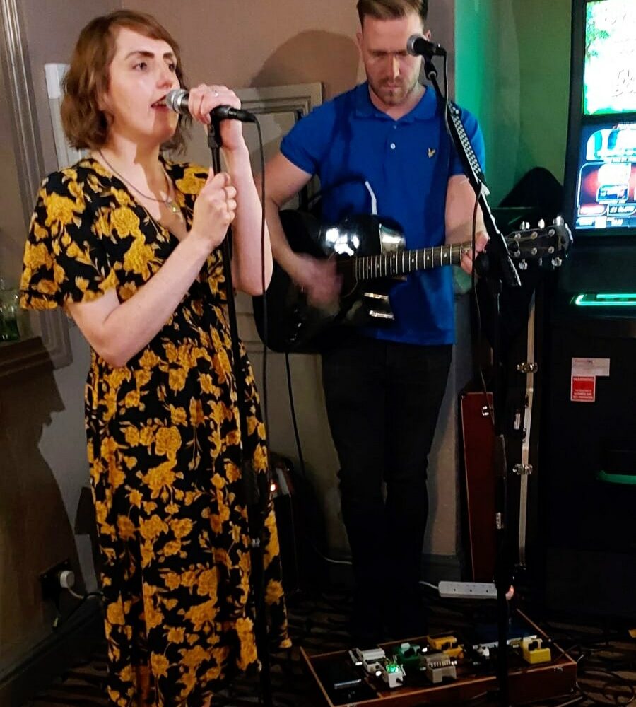 Billy and Lu playing guitar and singing